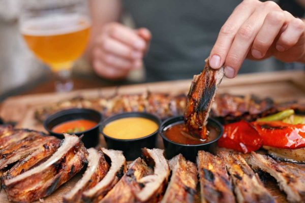 ribs dipped in three different sauces