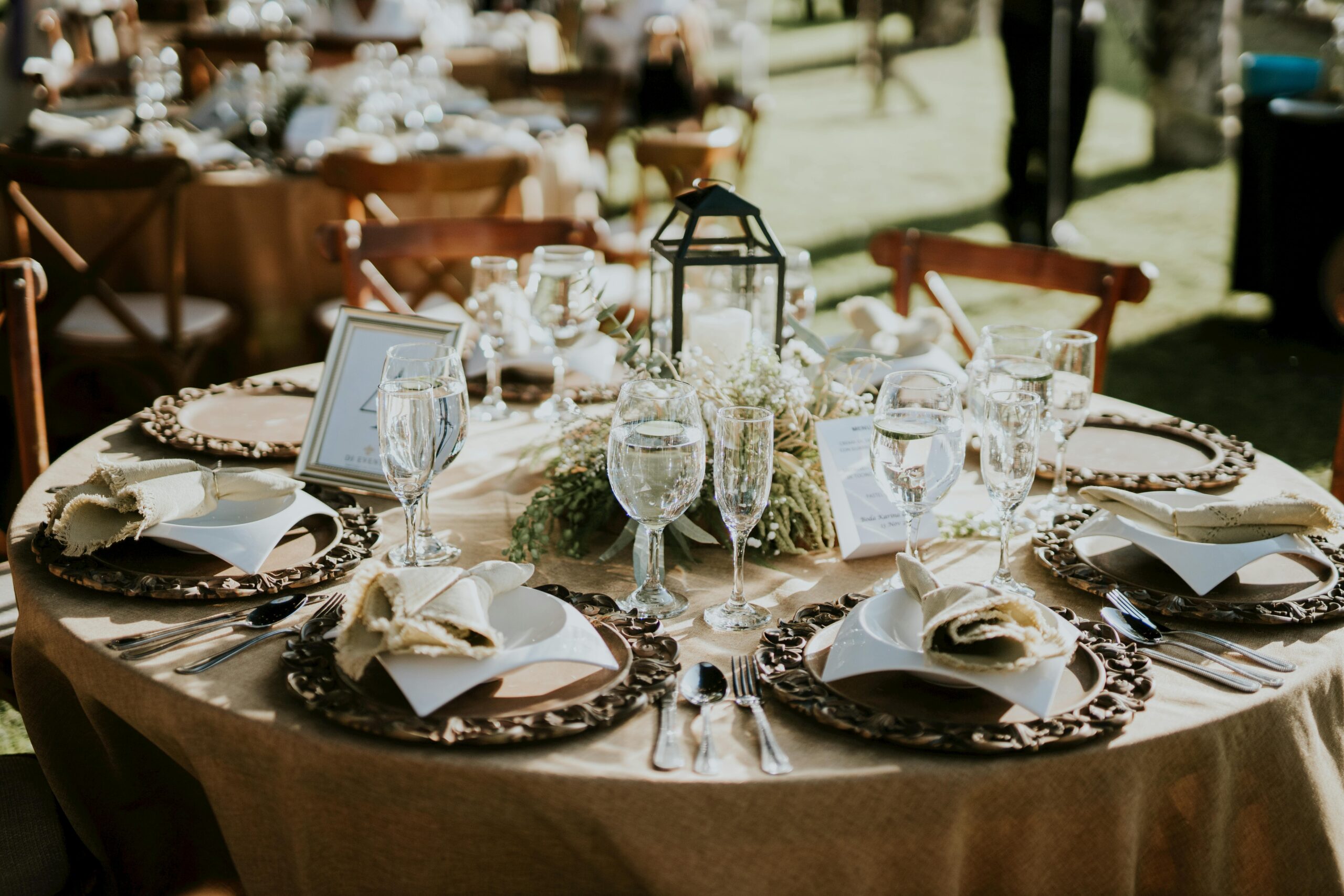 A beautifully decorated outdoor wedding ceremony at a San Antonio venue, surrounded by greenery and vibrant florals.